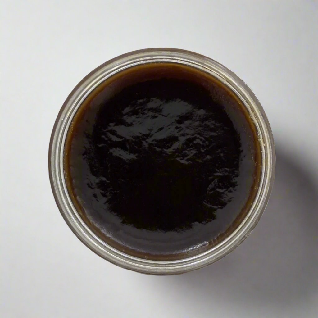 Jar of authentic beldi black soap with a smooth, dark texture, made from natural olive paste, perfect for gentle exfoliation and deep cleansing as part of a traditional Moroccan hammam ritual.