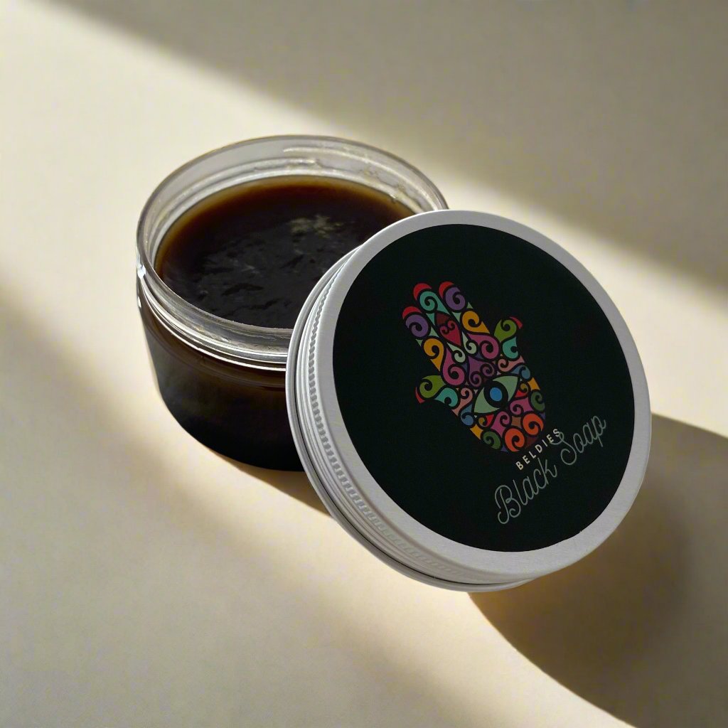 Jar of authentic beldi black soap with a smooth, dark texture, made from natural olive paste, perfect for gentle exfoliation and deep cleansing as part of a traditional Moroccan hammam ritual.