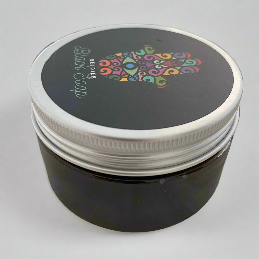 Jar of authentic beldi black soap with a smooth, dark texture, made from natural olive paste, perfect for gentle exfoliation and deep cleansing as part of a traditional Moroccan hammam ritual.