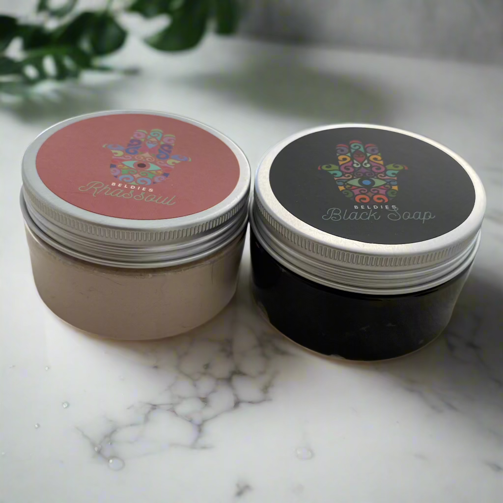 Beldies Rhassoul and Moroccan Black Soap Set, featuring the jars of Rhassoul clay and Moroccan Black Soap.
