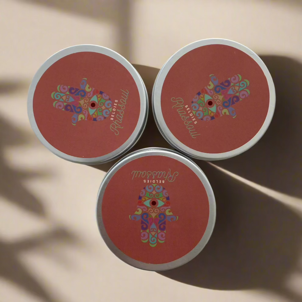 Three closed jars of Beldies Rhassoul clay neatly arranged, each containing premium, all-natural clay known for its detoxifying and skin-nourishing properties, ideal for facial and body masks.