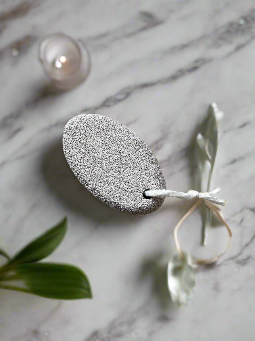 Close-up image of a Beldies pumice stone, showcasing its natural texture and ergonomic shape, designed for effective exfoliation and smooth skin care.