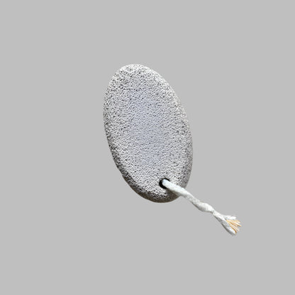 Close-up image of a Beldies pumice stone, showcasing its natural texture and ergonomic shape, designed for effective exfoliation and smooth skin care.