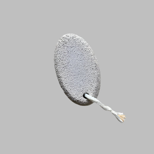 Close-up image of a Beldies pumice stone, showcasing its natural texture and ergonomic shape, designed for effective exfoliation and smooth skin care.