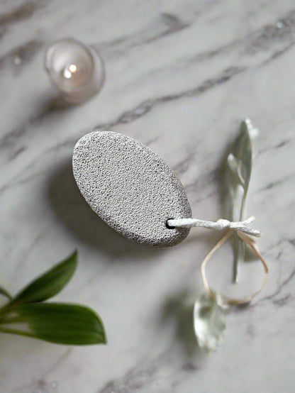 Close-up image of a Beldies pumice stone, showcasing its natural texture and ergonomic shape, designed for effective exfoliation and smooth skin care.